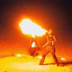 Picture spitting fire during fire show at Kukua Beach Club wedding reception